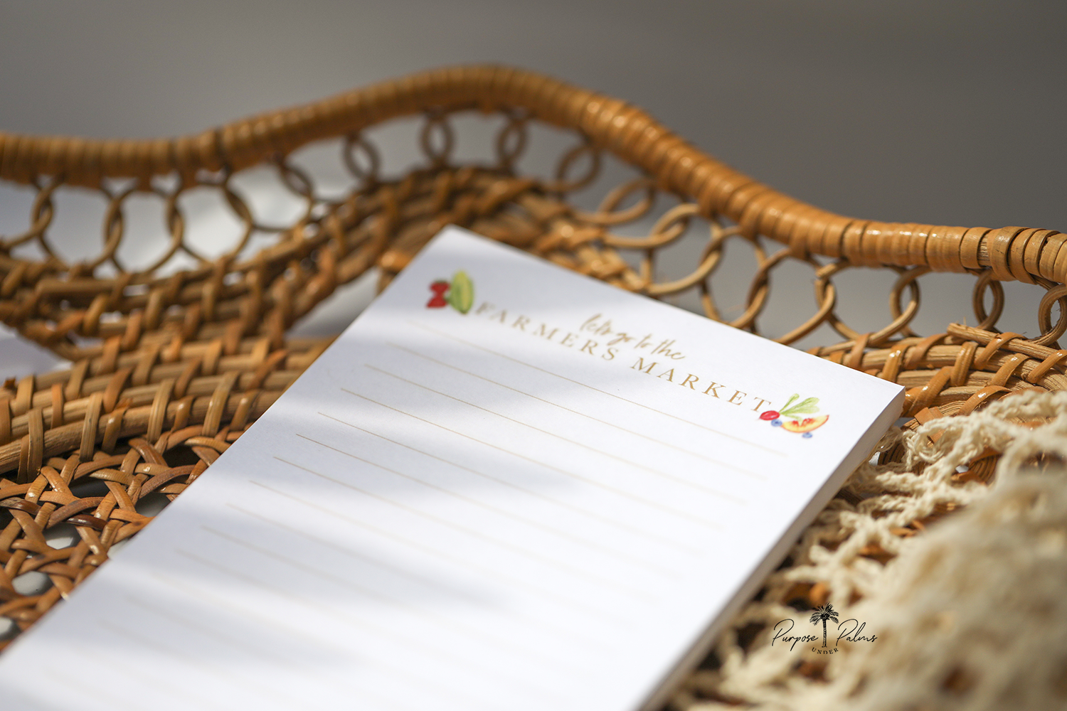 white grocery list notepad. lets go to the farmers market shown at top with fruits and vegetables on each side. lines down to the bottom. watercolor fruits and vegetables at the bottom with a mesh farmers market bag and a bouquet of flowers.
