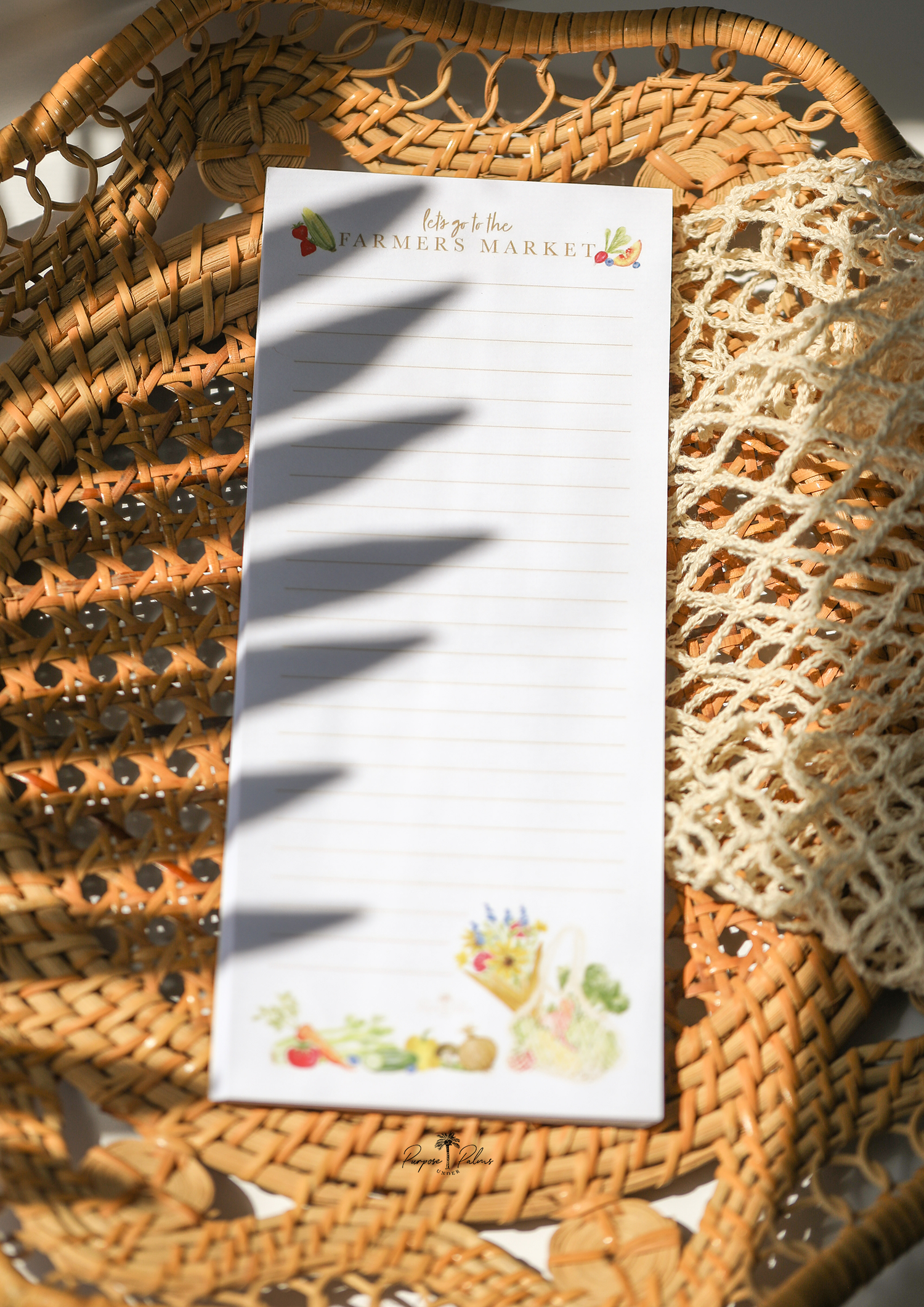 white grocery list notepad. lets go to the farmers market shown at top with fruits and vegetables on each side. lines down to the bottom. watercolor fruits and vegetables at the bottom with a mesh farmers market bag and a bouquet of flowers.