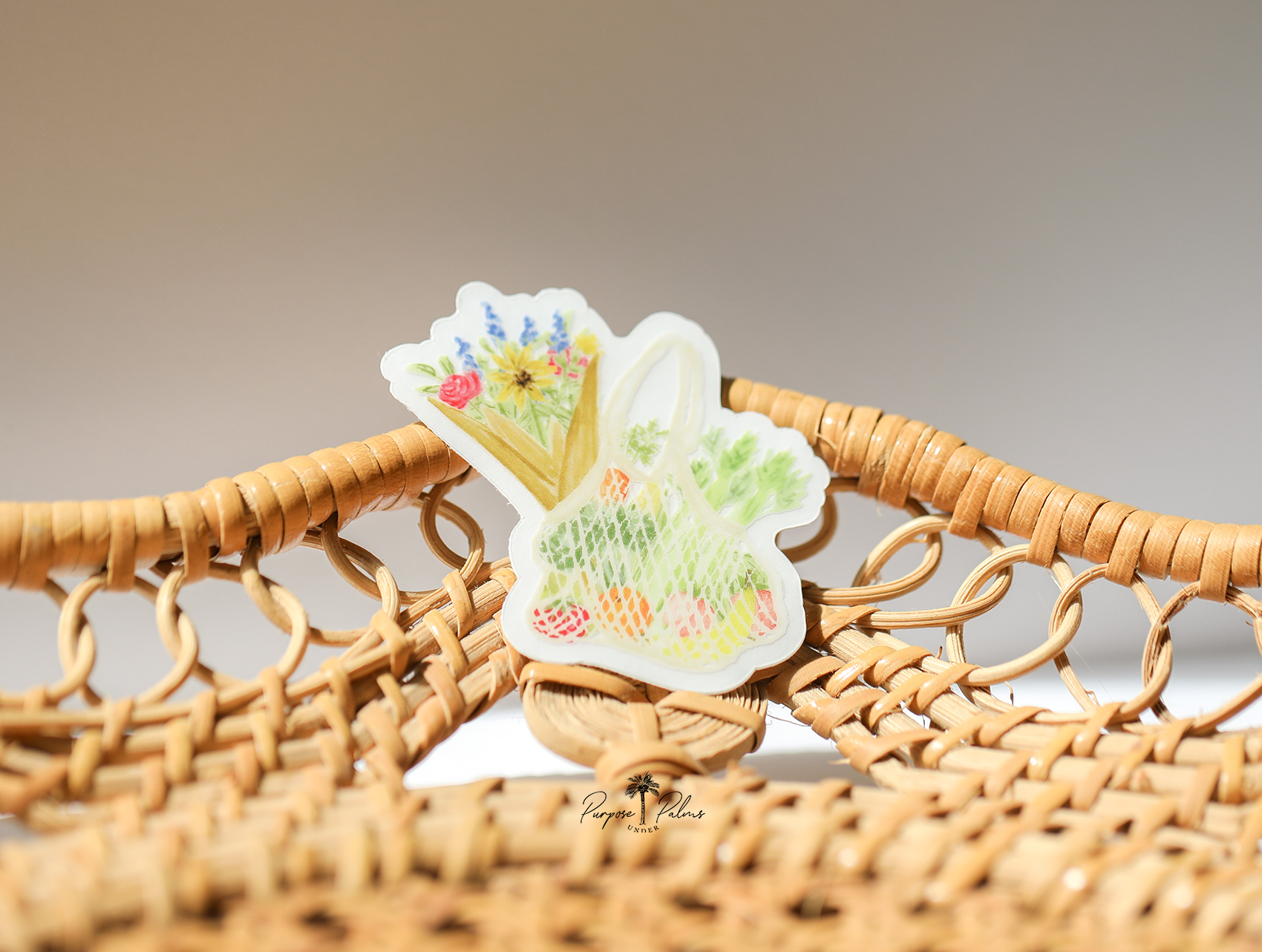 small clear sticker of farmers market mesh bag with fruits and veggies inside and a bouquet of flowers sticking out of the side.