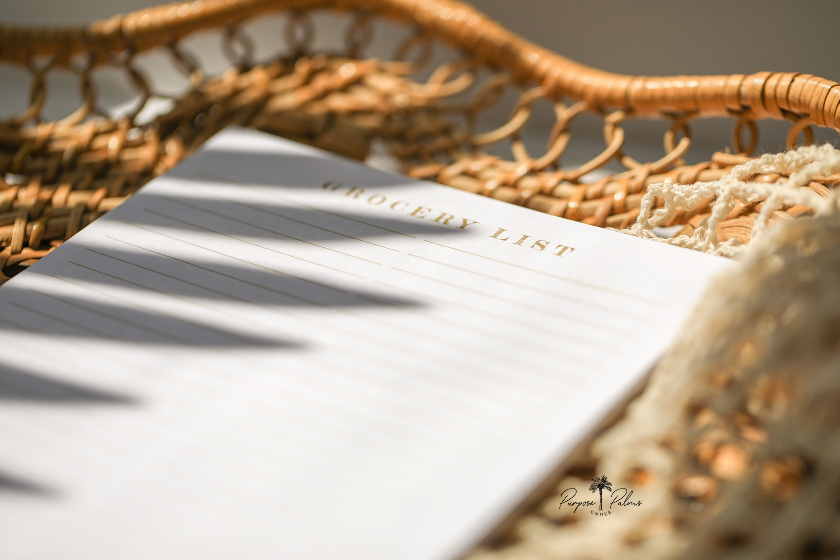 white grocery list notepad with grocery list at the top and two lined columns. watercolor fruits and vegetables at the bottom.